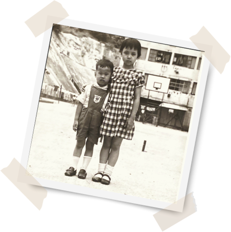 Jenny Seagraves, age 8, with her brother outside her home in Hong Kong.